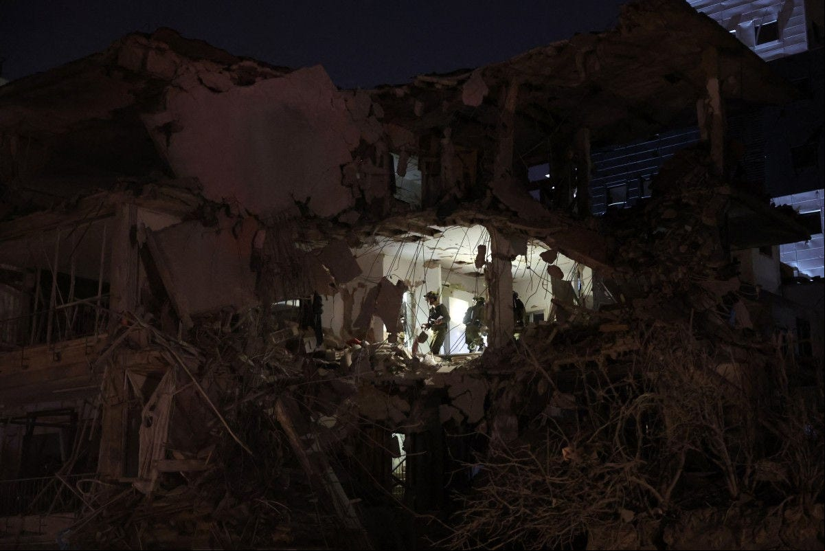 EDITORS NOTE: Graphic content / Israeli troops check a building hit by a missile fired from Iran, in Ramat Gan near Tel Aviv on June 13, 2025. Iran fired a barrage of ballistic missiles at Israel in a counter-strike in the evening on June 13, after an unprecedented onslaught hammered the Islamic republic's top military brass and targeted its nuclear facilities and bases. (Photo by Jack GUEZ / AFP)